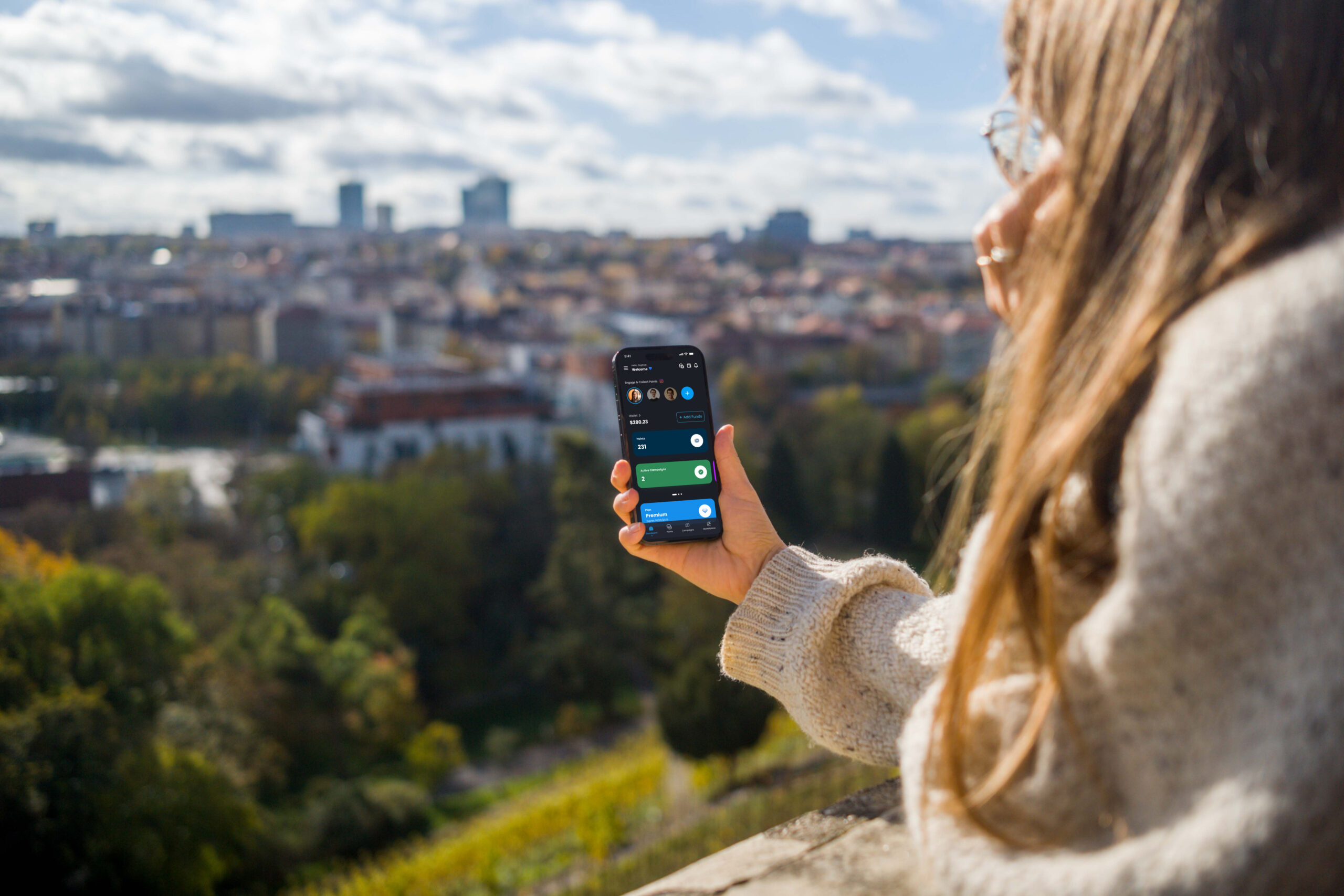 mockuuups woman hand holding an iphone with city view mockup scaled